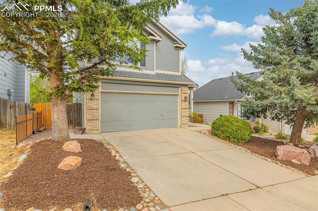 Image 3 of 41: Two-story exterior with gray siding and brick accents