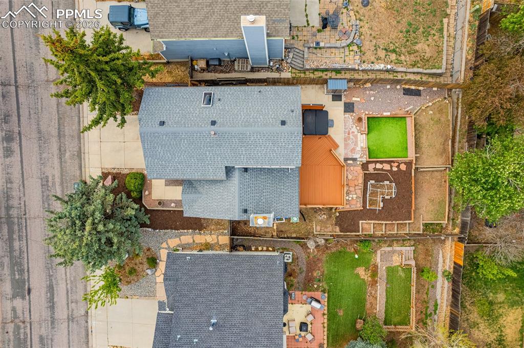Image 32 of 41: Rear exterior featuring a multi-level deck, artificial turf area, and tiere