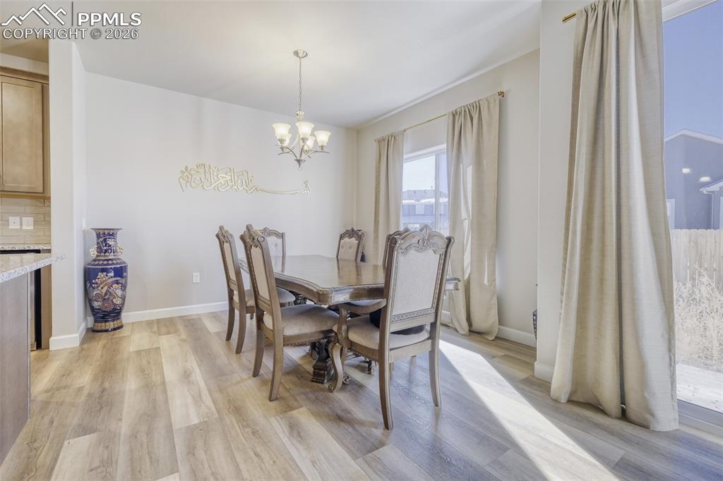 Image 10 of 42: dining room with walkout access to backyard