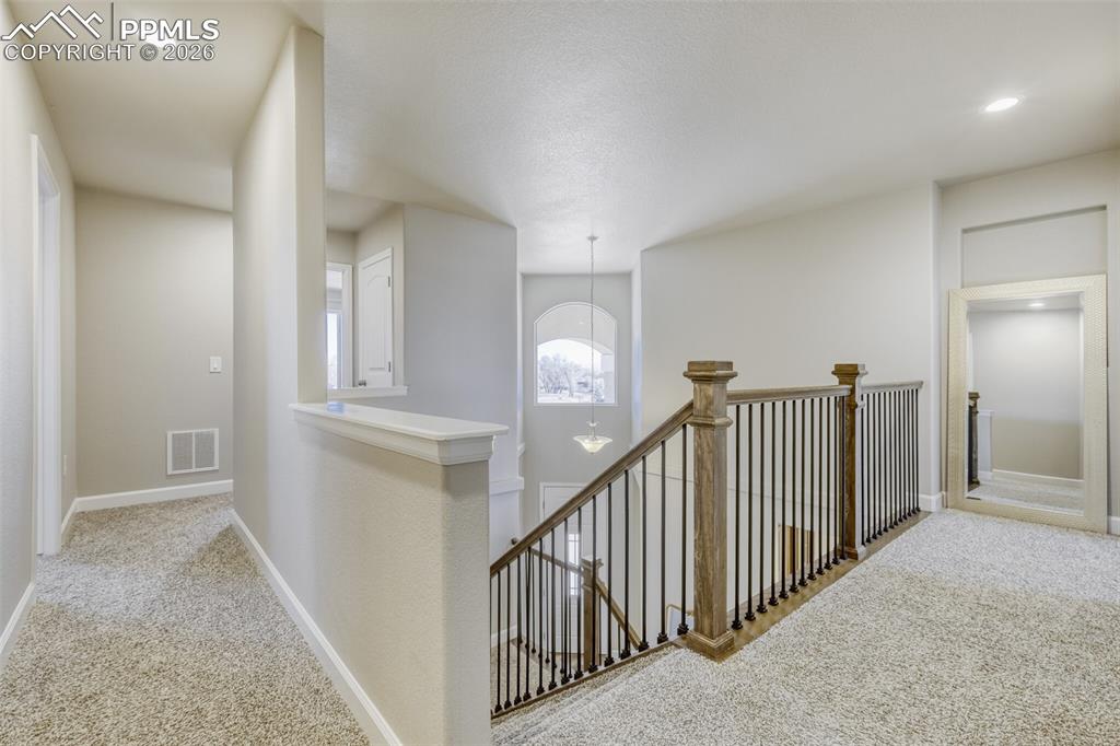 Image 16 of 42: stairs to upper level bedrooms and laundry room