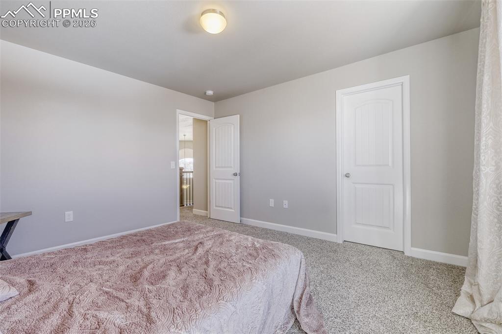 Image 24 of 42: upper level second bedroom