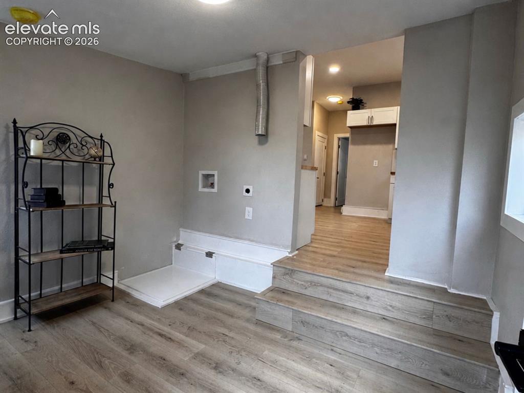 Image 27 of 27: Laundry/Mud Room with walk-out to backyard.