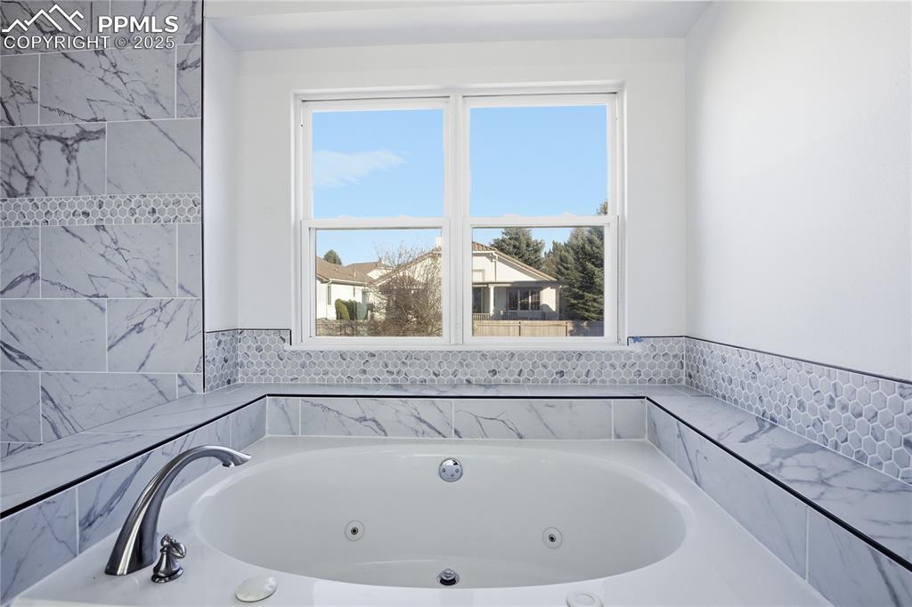 Image 23 of 42: Bathroom featuring a jetted tub