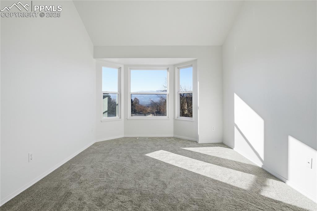 Image 27 of 42: Unfurnished room featuring carpet floors and vaulted ceiling