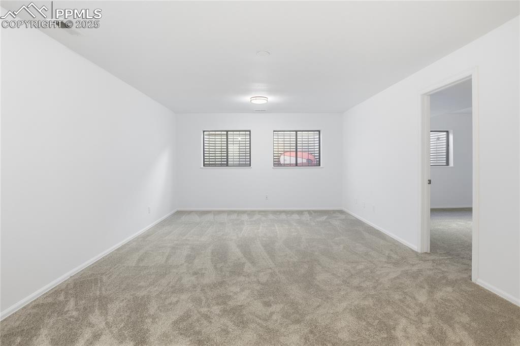 Image 31 of 42: Unfurnished room with light colored carpet and baseboards