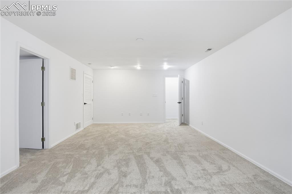 Image 32 of 42: Unfurnished room with light carpet and baseboards