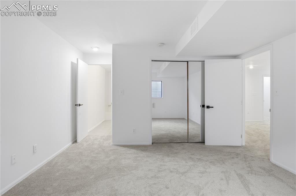 Image 33 of 42: Unfurnished bedroom featuring light carpet and a closet