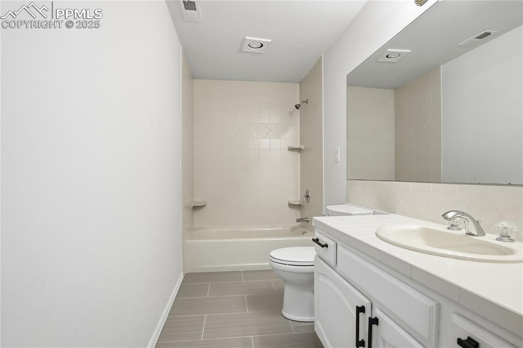 Image 35 of 42: Bathroom featuring vanity and  shower combination