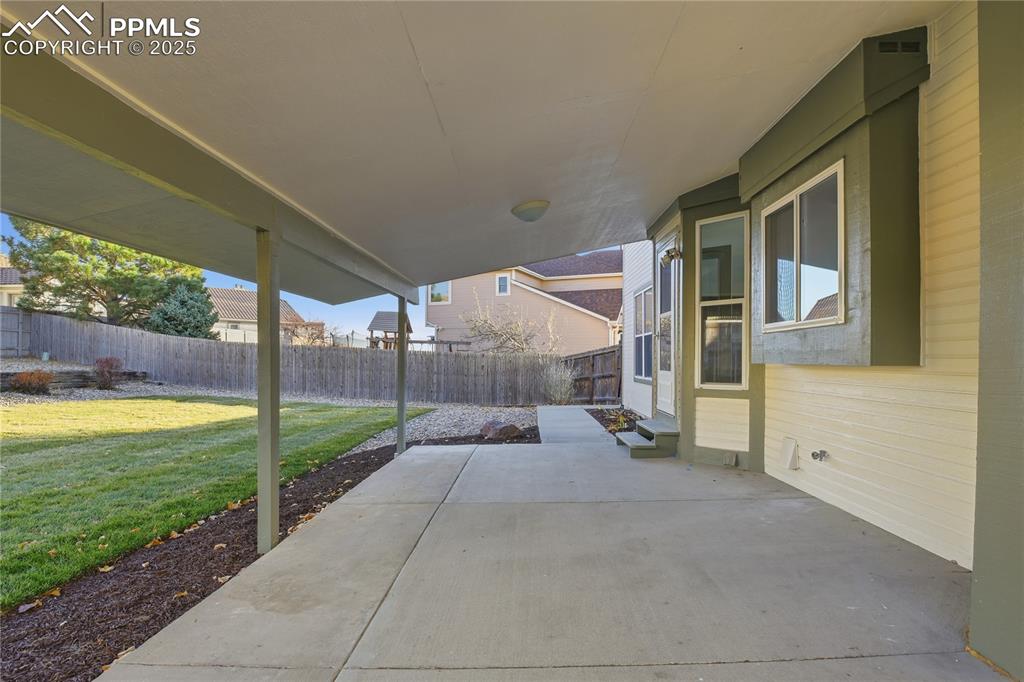Image 37 of 42: Fenced backyard featuring a patio area