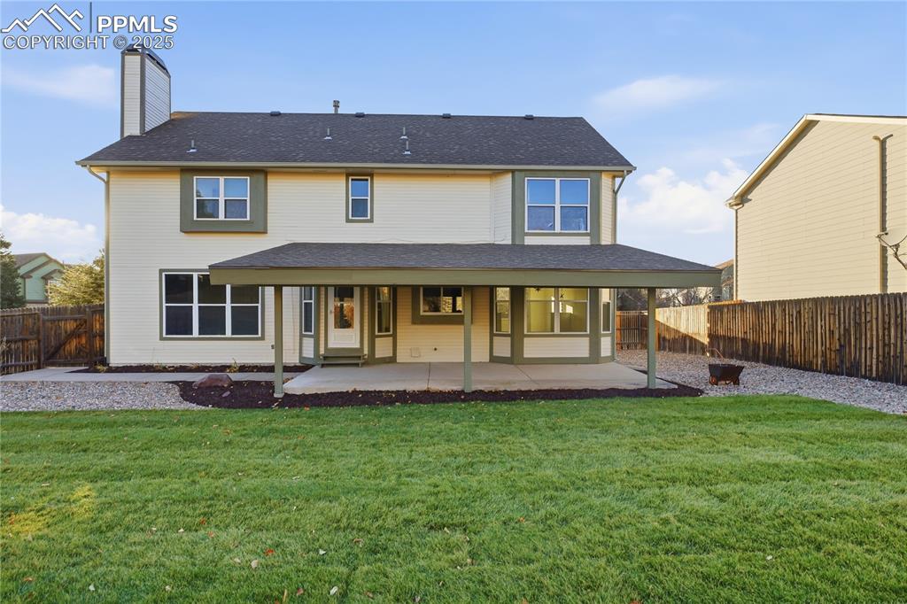 Image 39 of 42: Back of property with a patio area, a chimney, a fenced backyard, and a shi