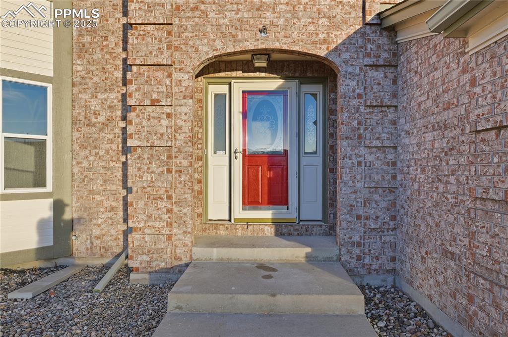 Image 41 of 42: Property entrance with brick siding