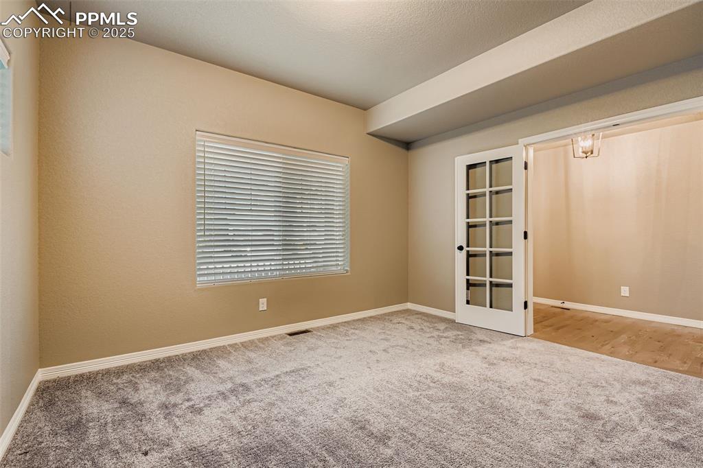 Image 7 of 28: Spare room with carpet floors and plenty of natural light