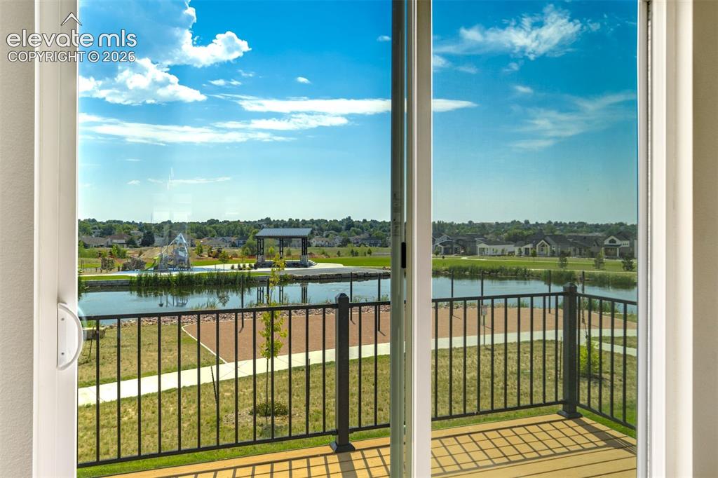 Image 22 of 50: Sliding glass door in the dining room leads to a view of the lake, event pa