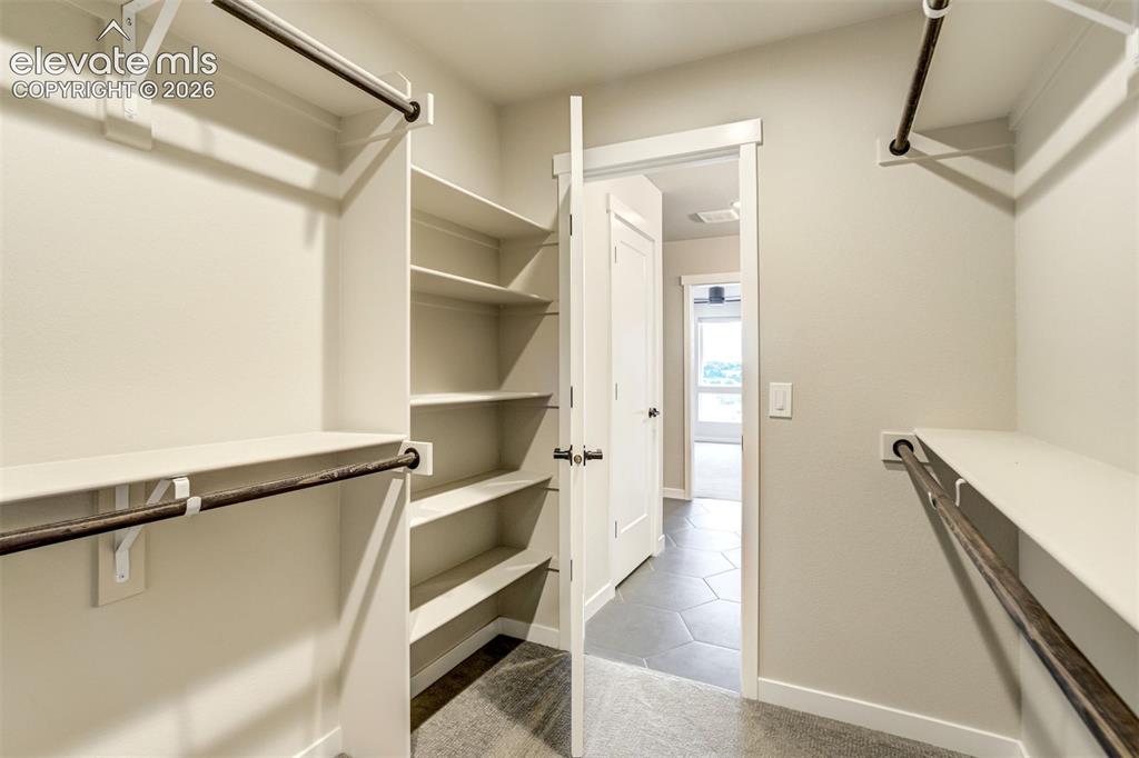 Image 36 of 50: Primary bedroom walk-in closet