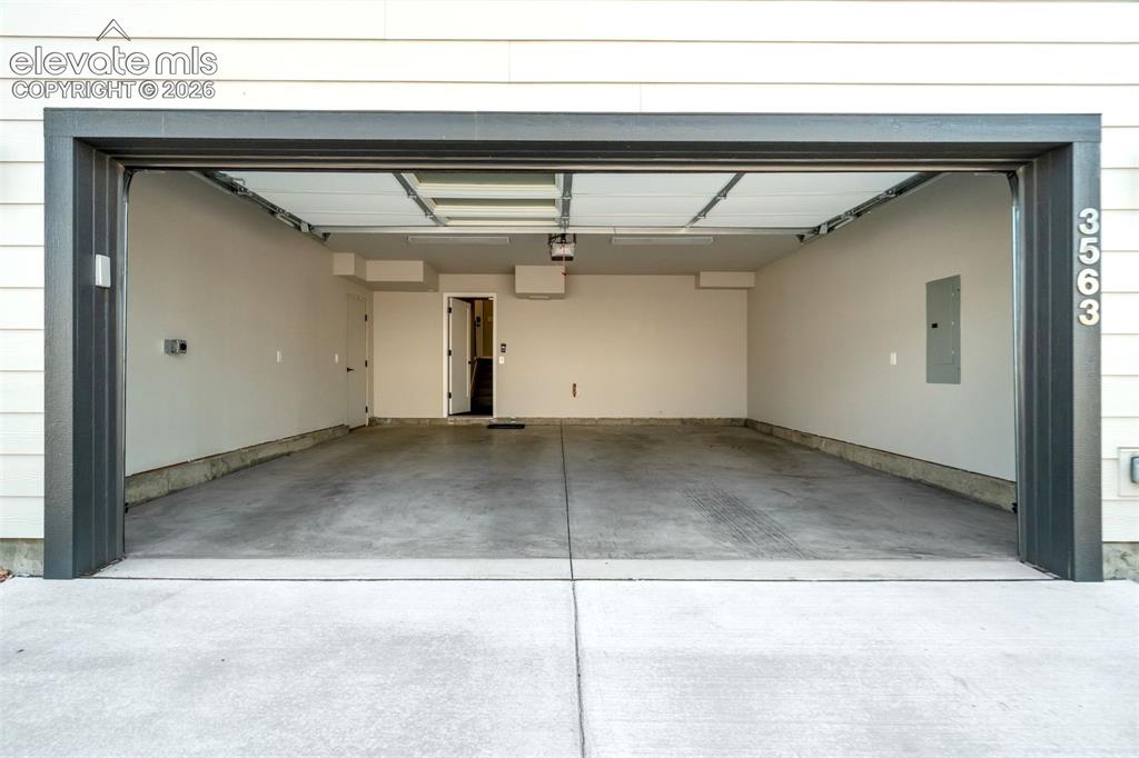 Image 46 of 50: Two-car garage with side access and 220V 
