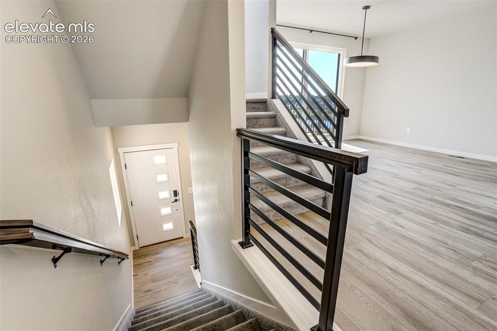 Image 8 of 50: From the front door, go down to an extra bedroom/office and the garage, or 