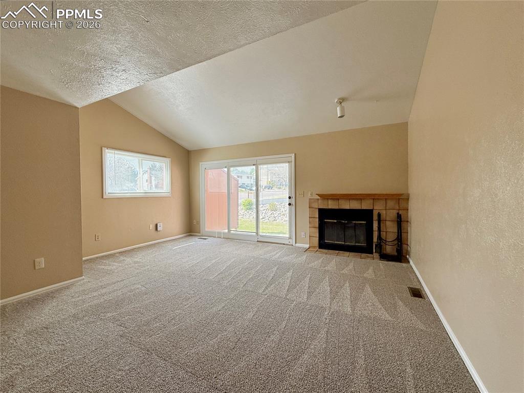 Image 8 of 18: Spacious living room with fireplace that walks out to your patio