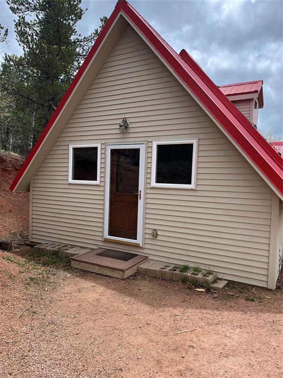 Image 2 of 10: Enter the back of the house from parking into a all purpose room with laund