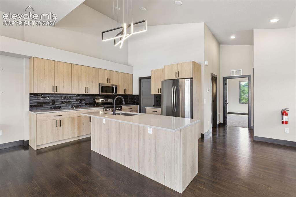 Image 16 of 50: Expansive Island, Abundant Cabinets
