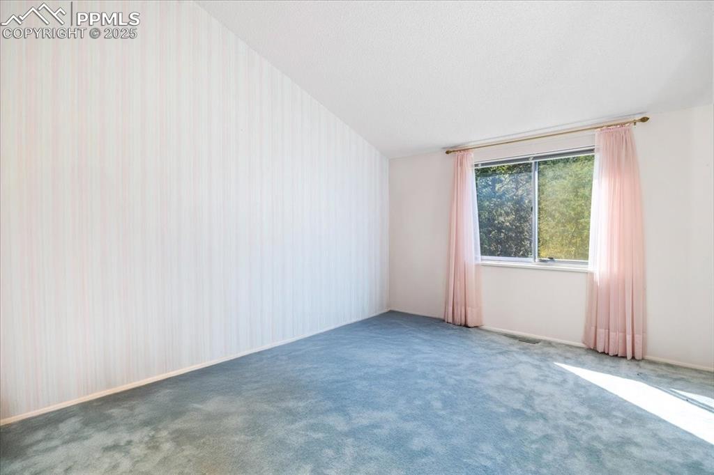 Image 20 of 38: Carpeted spare room with baseboards