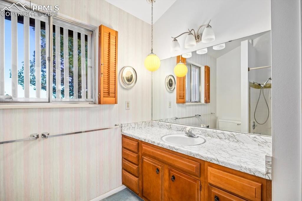 Image 23 of 38: Full bath featuring vanity and wallpapered walls