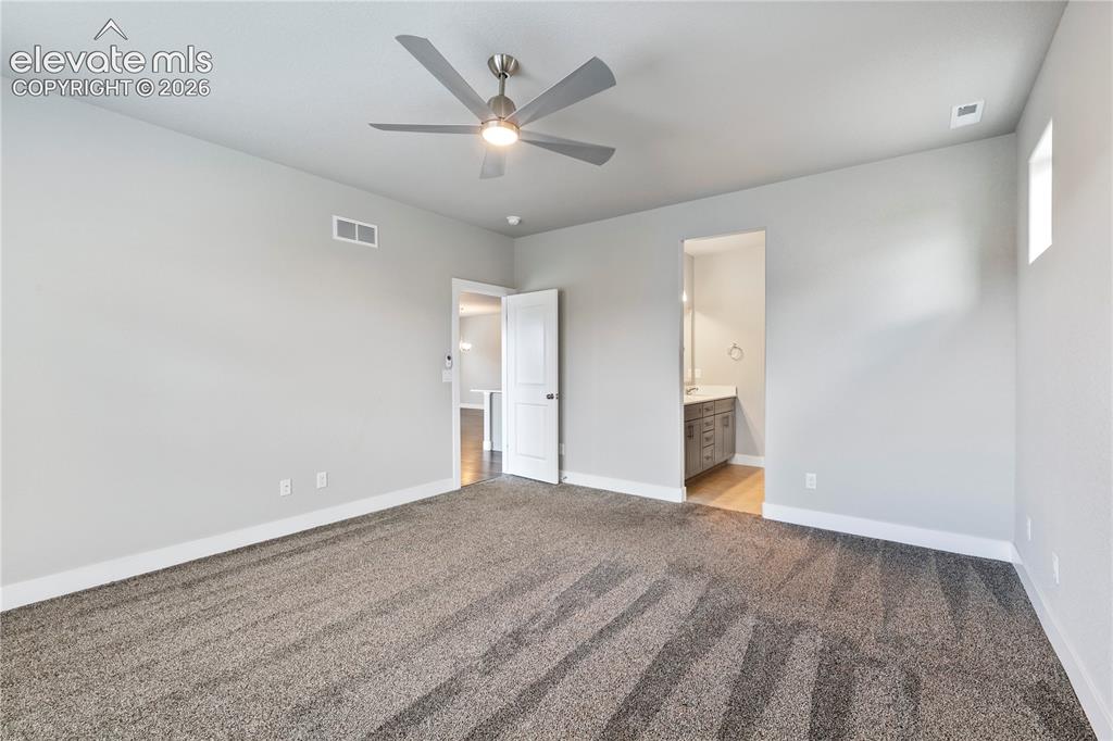 Image 12 of 22: Spacious primary bedroom on main level