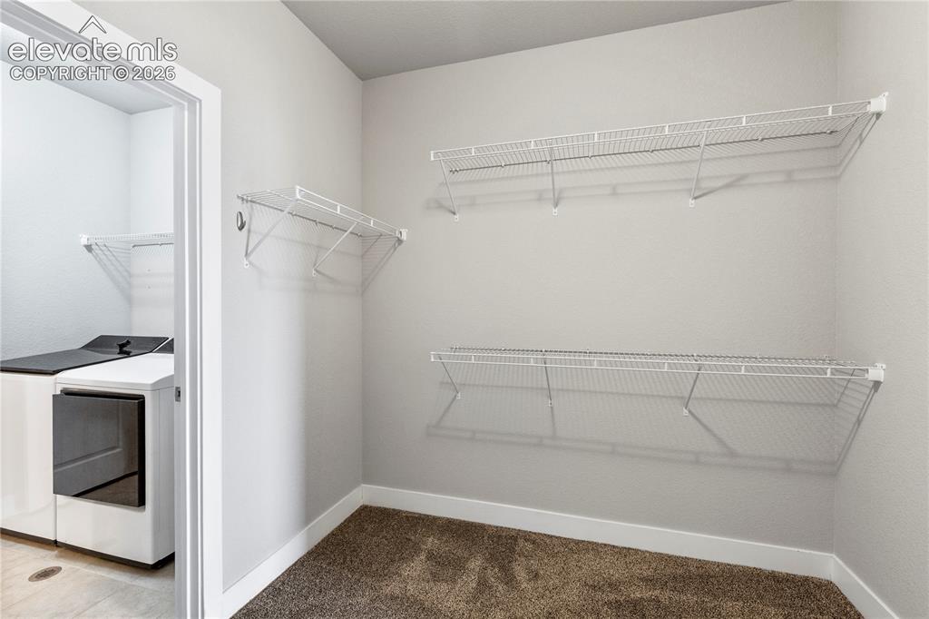 Image 15 of 22: Walk in closet for primary bedroom