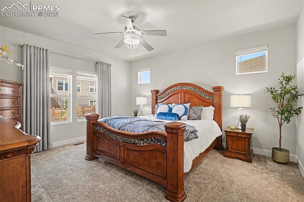 Image 14 of 37: A sparkling crystal chandelier adds elegance, while a large window fills th