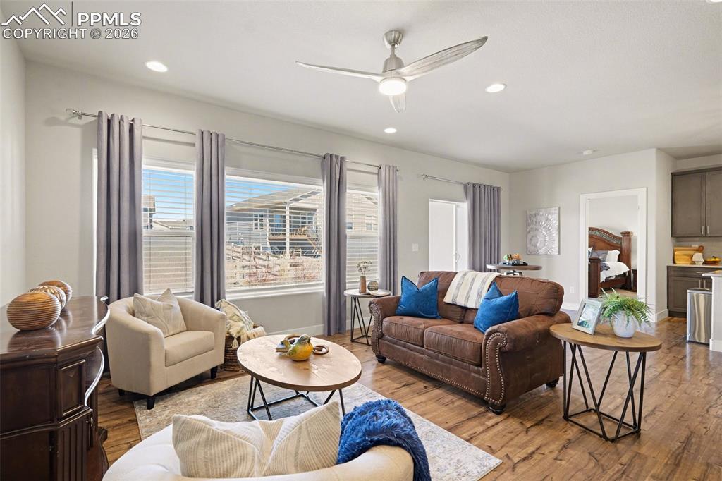 Image 18 of 37: The living room features a large window that fills the space with natural l