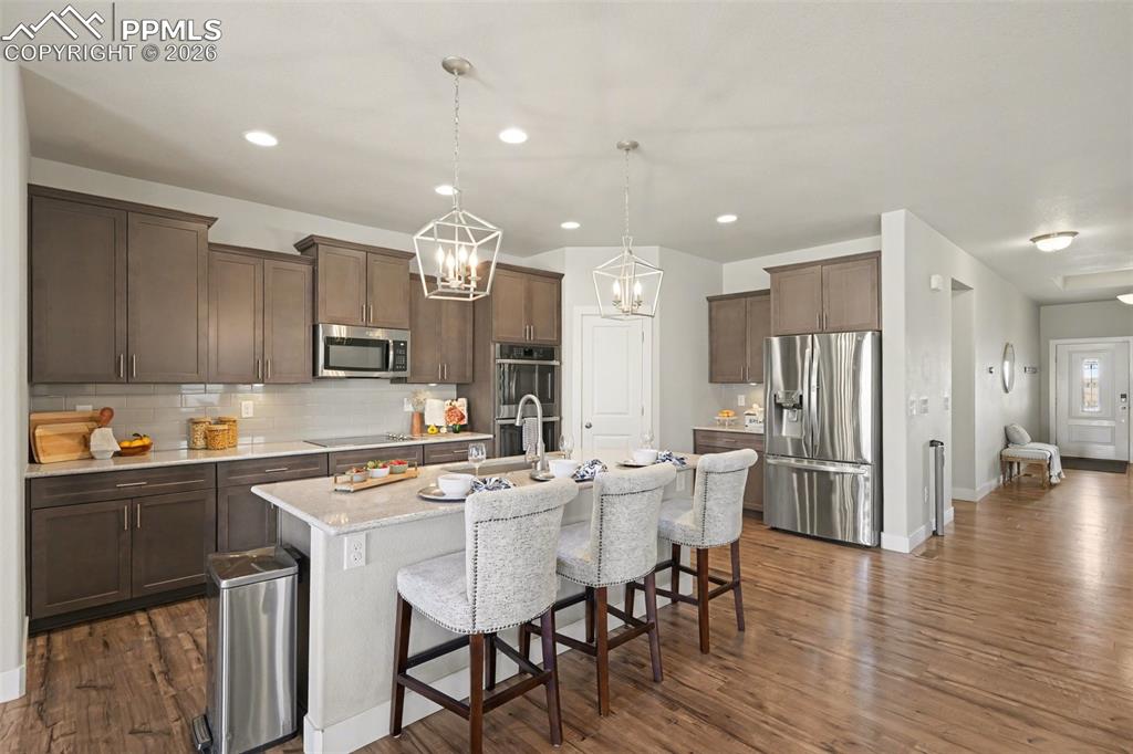 Image 23 of 37: The heart of the main-level open space is the gourmet kitchen, featuring st