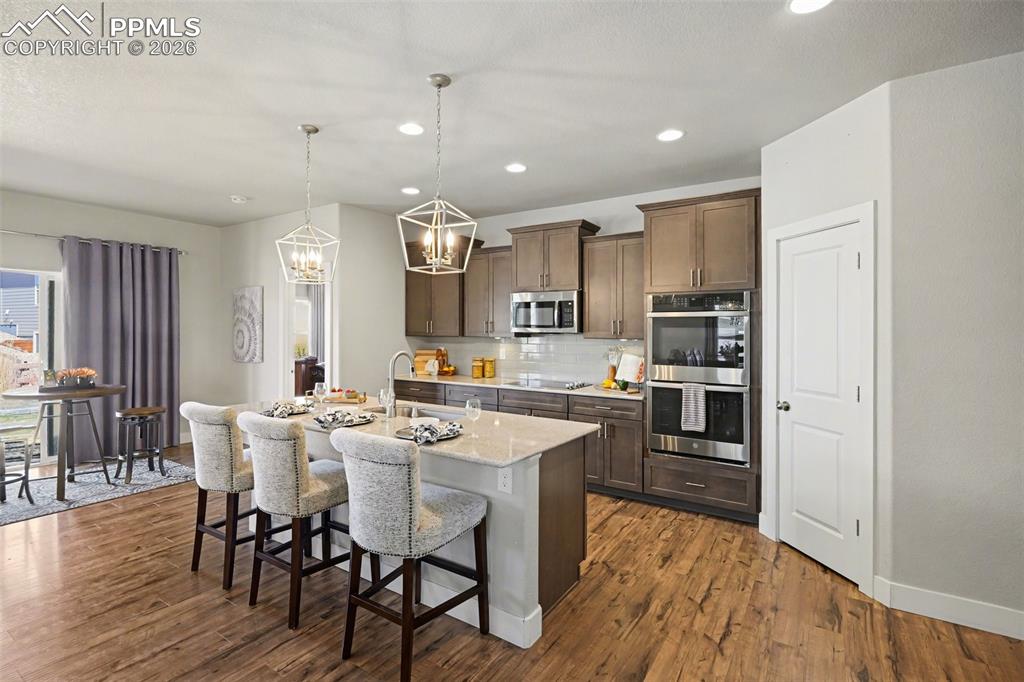 Image 24 of 37: A spacious walk-in pantry adds functional storage, and the kitchen’s seamle