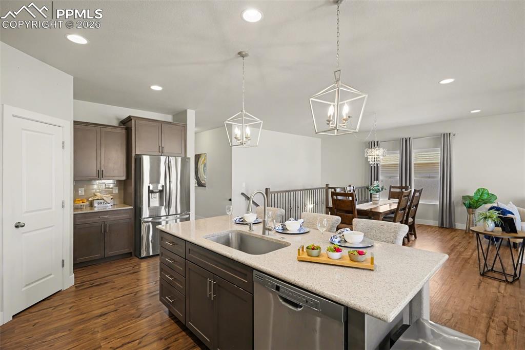 Image 25 of 37: A large center island serves as the perfect gathering spot, ideal for enter