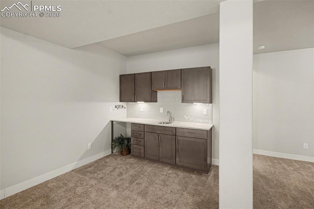 Image 29 of 37: The basement features a wet bar, providing a perfect space for entertaining