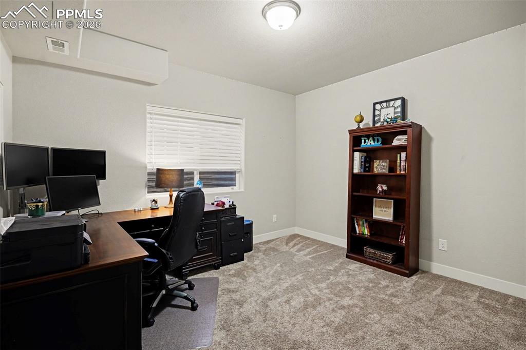 Image 31 of 37: The basement includes a spacious bedroom that can easily double as a home o