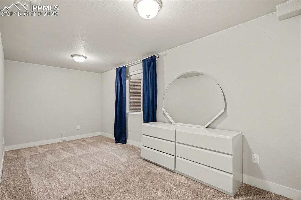 Image 33 of 37: The basement features a second bedroom, providing additional living space f