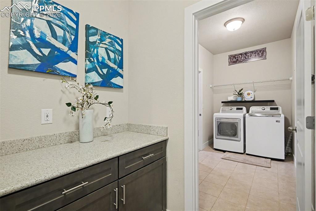 Image 9 of 37: The wide main-level hallway provides easy access to the garage and a spacio