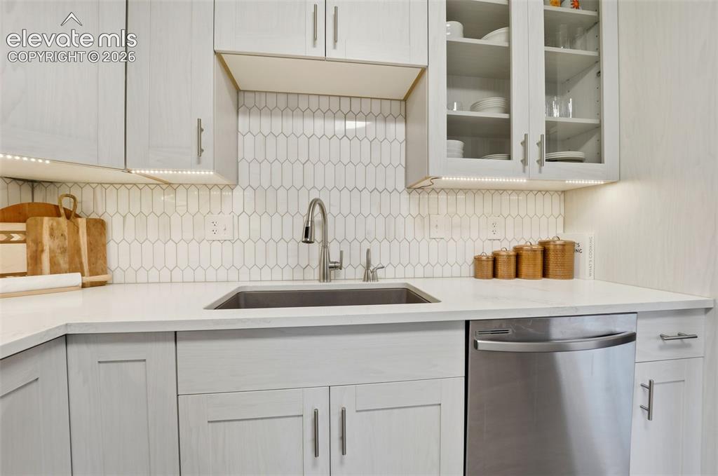 Image 15 of 38: Contemporary kitchen featuring light wood-finish cabinetry, a stainless ste