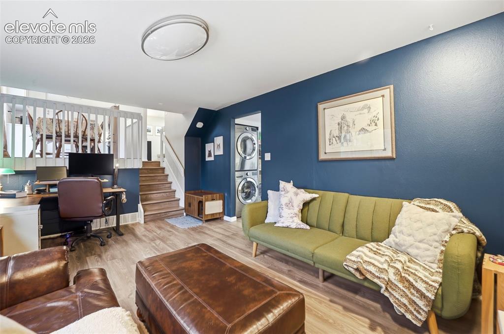 Image 25 of 38: Interior space featuring wood-finish flooring, a vibrant blue accent wall,