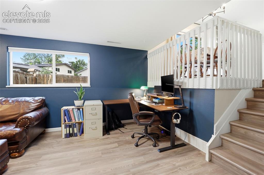Image 27 of 38: Lower-level space featuring wood-finish flooring, a contemporary window, an