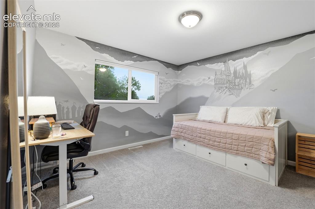 Image 31 of 38: Carpeted room featuring a white-framed window, recessed lighting, and wall