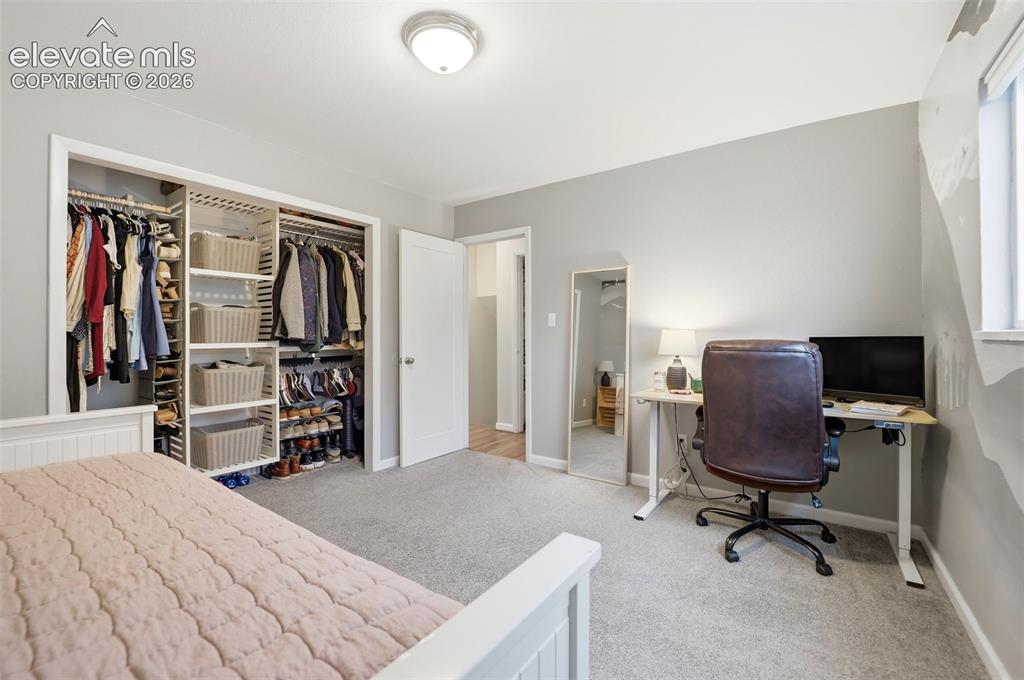 Image 33 of 38: Wall-to-wall carpeting and neutral wall tones create a versatile interior