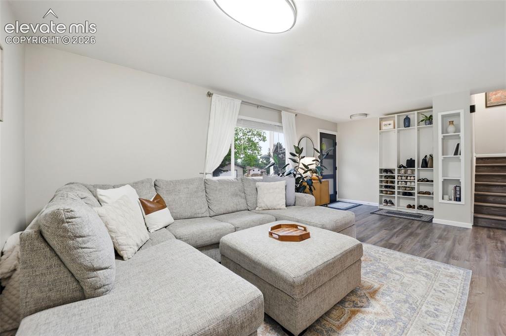 Image 7 of 38: Open-concept living area featuring wood-finish flooring throughout