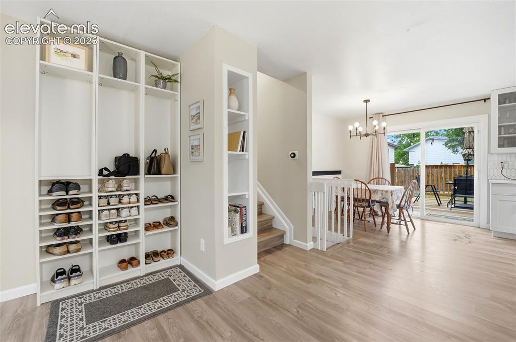 Image 8 of 38: Living area with a large picture window, ceiling-mounted light fixture, lig