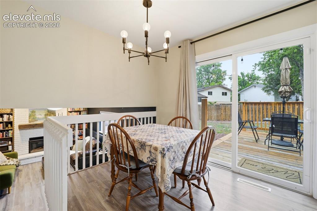 Image 9 of 38: Open concept living area featuring wood-finish flooring, neutral wall tones