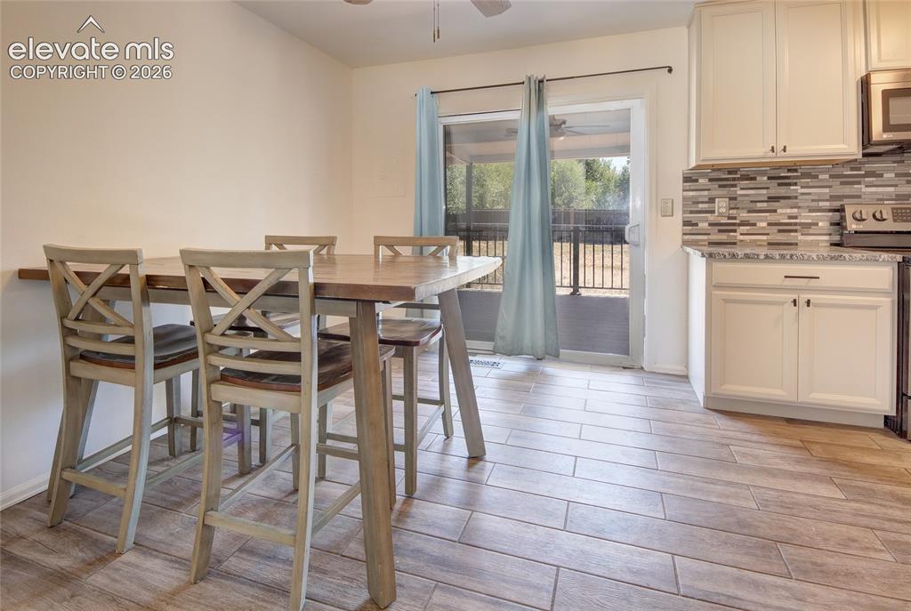 Image 6 of 26: Kitchen walks out to deck
