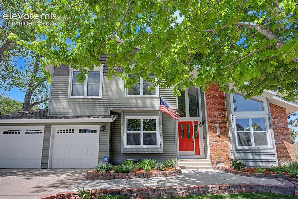 Image 10 of 47: Bold Pop of Red on the front door