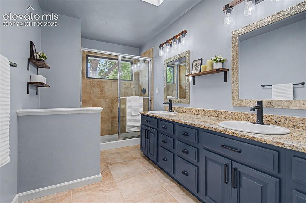 Image 28 of 47: Primary Bath with double vanity