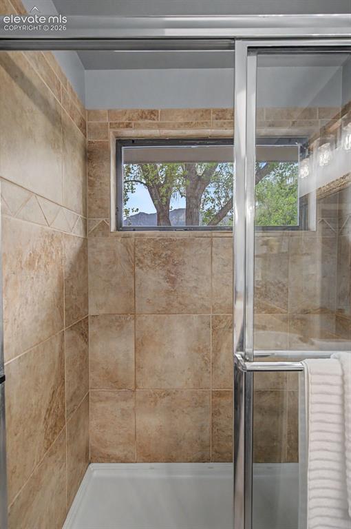 Image 29 of 47: Shower with views of Cheyenne Mountain