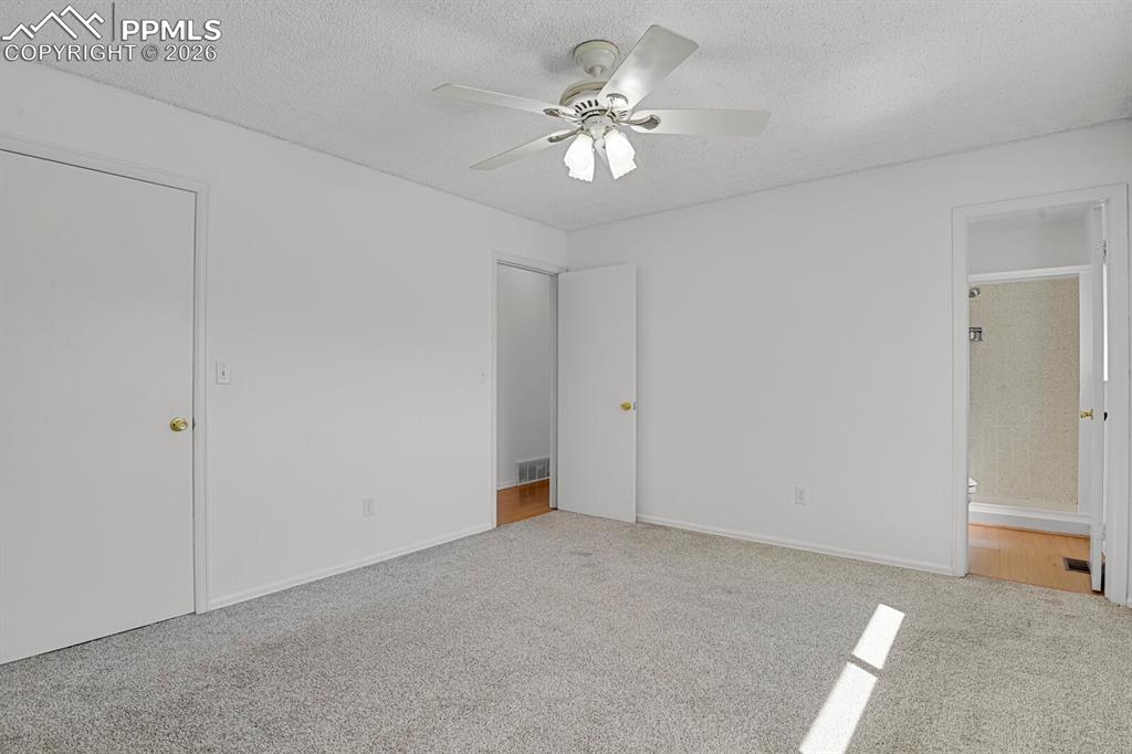 Image 16 of 30: Bedroom featuring a ceiling fan with light fixture, carpeted flooring, and 
