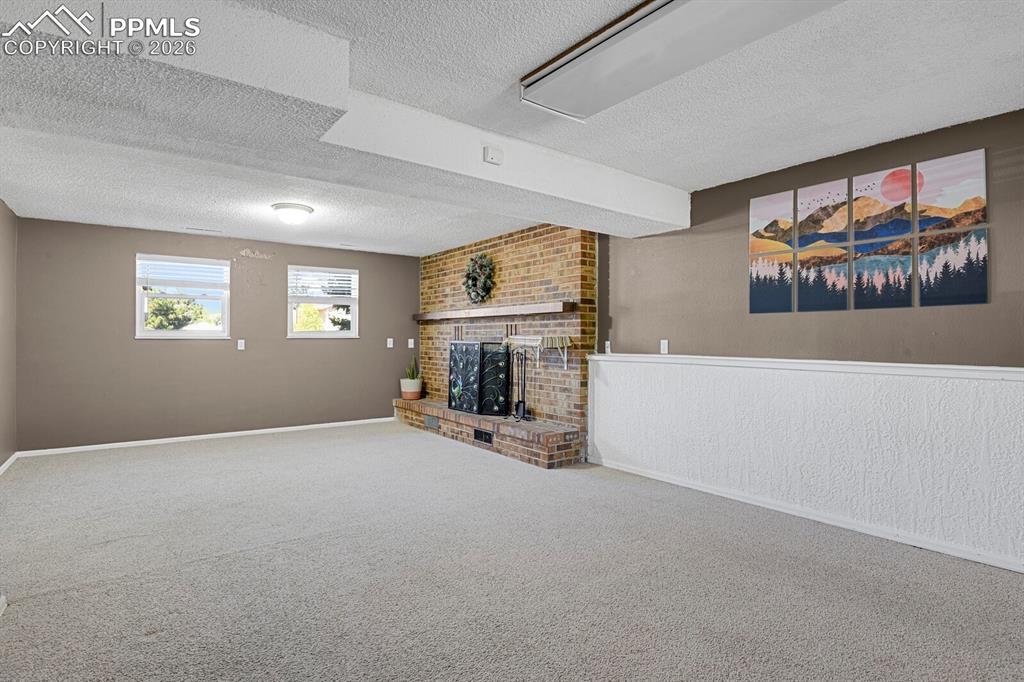 Image 19 of 30: Spacious Family room featuring light-colored carpeting, two windows, and a 